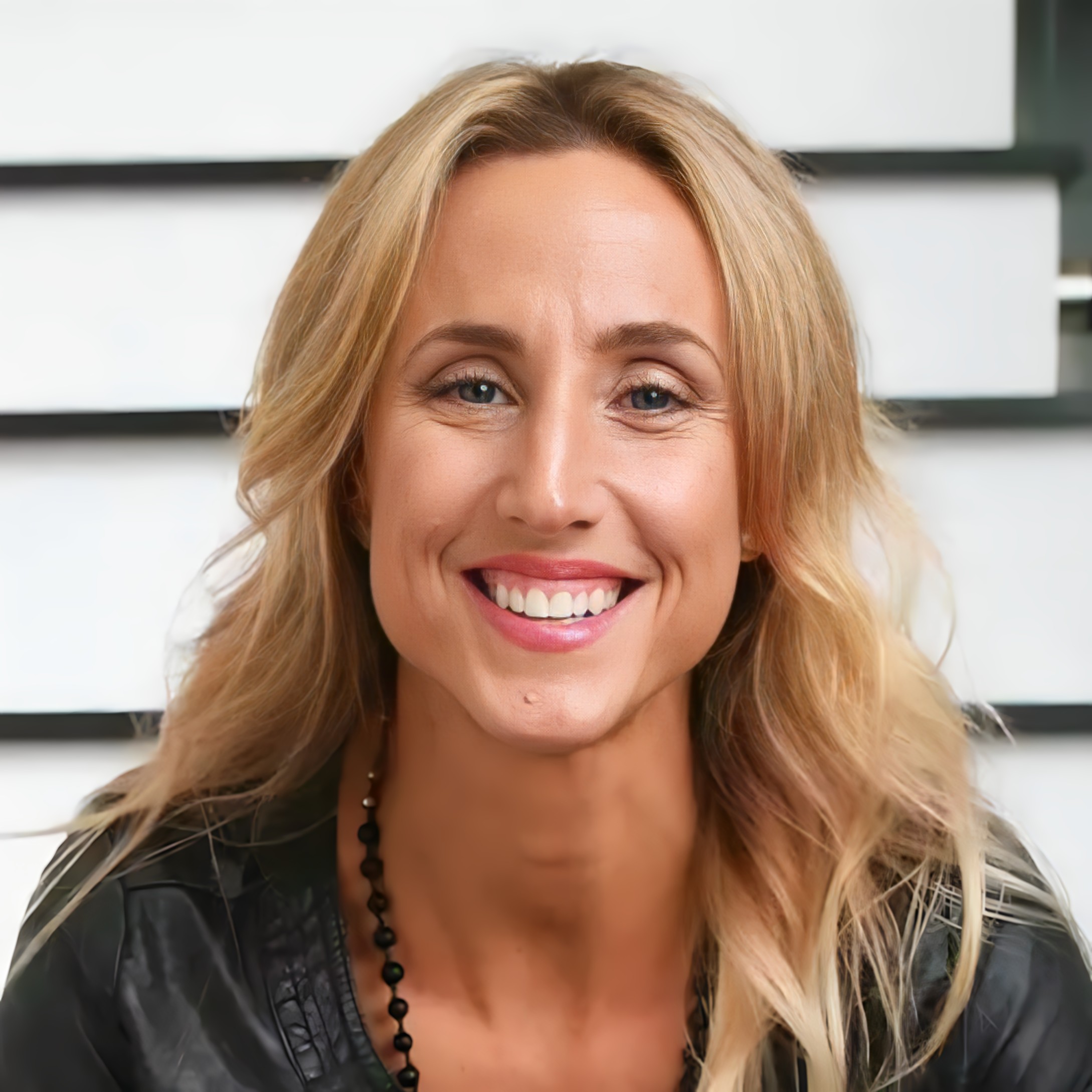 Close-up portrait of a women’s wellness coach discussing breathwork, hormone balance, and recovery.